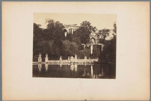 View of a villa seen from the garden with a pond in the foreground