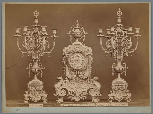 Table clock with two candlesticks