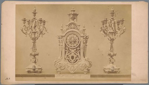 Table clock with two candlesticks
