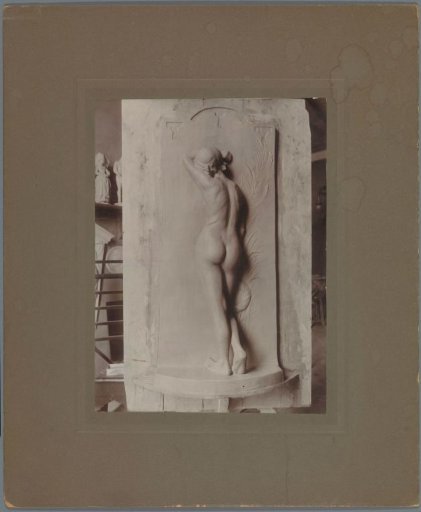 Sculpture of a woman seen from the back with her arm against her head