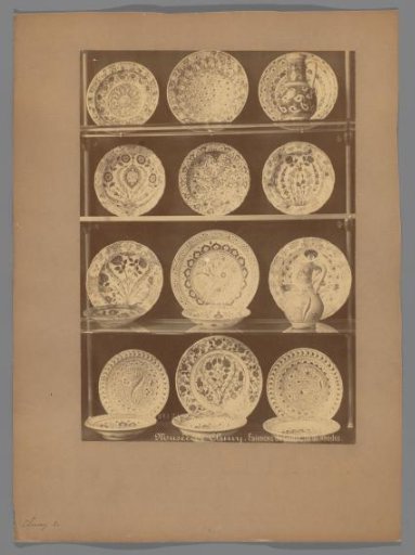 Seventeen plates and two ewers in a vitrine cabinet