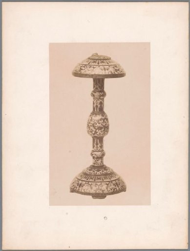 Object on a foot decorated with plant motifs, possibly an ashtray or a candlestick