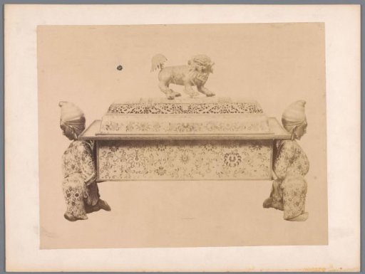 Chest decorated with Asian motifs, with two supporting men as legs and an openwork lid featuring a lion