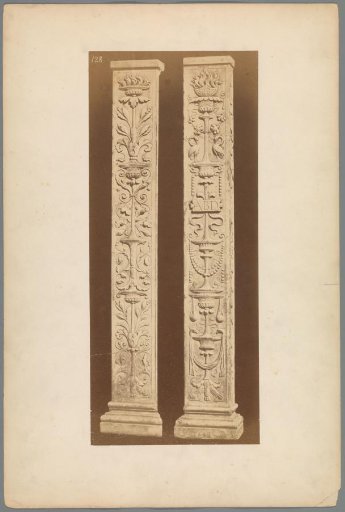 Two columns ornamented with leaf motifs, vases and bowls with fire
