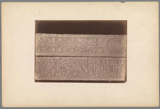 Relief with a leaf motif and the letters IHS