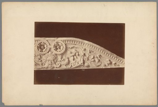 Relief with a mask head and a plant motif