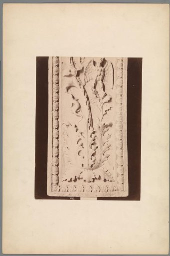 Relief with a leaf motif and the letters IHS