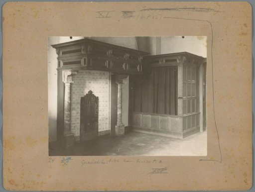 Interior of a room with a fireplace and a bed alcove