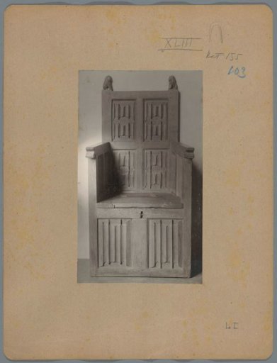 Armchair with a chest-shaped base, decorated with letter panels and heads of the rear stiles in the form of shield-bearing lions