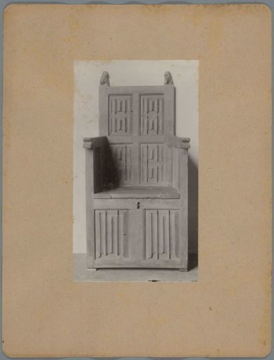 Armchair with a chest-shaped base decorated with letter panels and the heads of the rear stiles in the form of shield-bearing lions