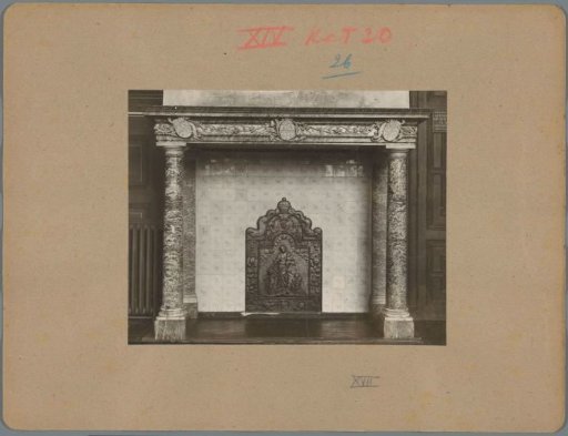 Fireplace with a grate featuring a relief of the virtue Caritas