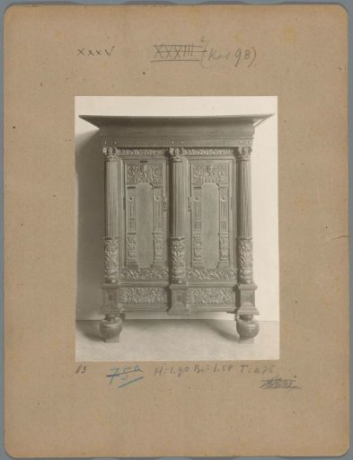 Cabinet decorated with heads, columns, and motifs of flowers and plants