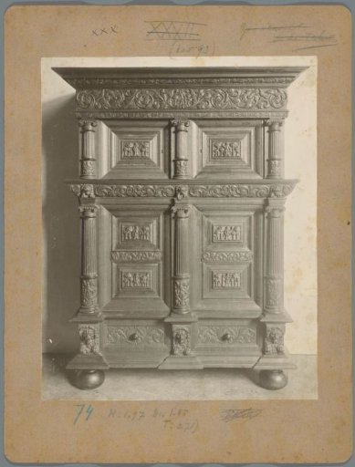 Cabinet with lower and upper sections, closed by four doors, between fluted pilasters, decorated with carved work of presumably religious scenes
