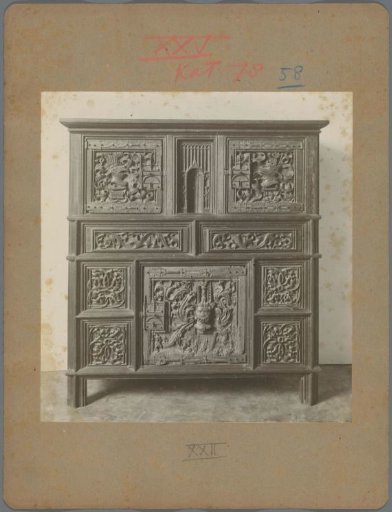 Cabinet with carved ornaments of plant motifs, animal heads, and Satan