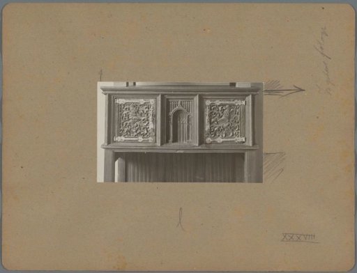 Detail of a cabinet with two doors ornamented with plant motifs and animal heads, and a niche-shaped form in the center