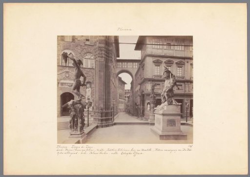 View from the Loggia dei Lanzi in Florence with a sculpture of Perseus and Medusa on the left and a sculpture of Judith and Holofernes on the right