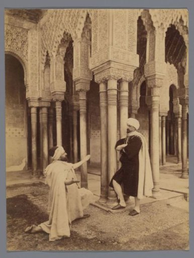 Staged scene with two unknown men in the Alhambra of Granada, one of them kneeling