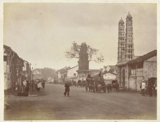 Local street scene in Singapore with towers of temples and mosques