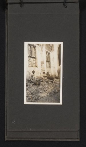 Three men sitting by a road near the souk in Fez