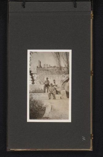 Two European men and a Moroccan man in the garden of the Resident General in Fez