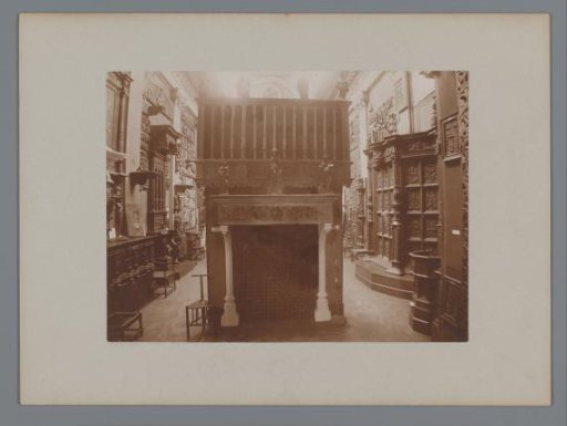 View of a hall with a fireplace and reliefs