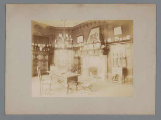 Interior with a desk, chairs, and decorative plates