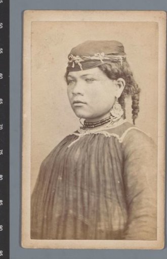 Portrait of a young woman in Egypt with braids, necklace and earrings
