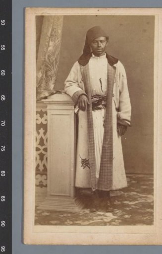 Studio portrait of a man in a long white coat