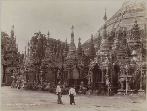Two people in front of the Shwedagon pagoda, Yangon, Myanmar