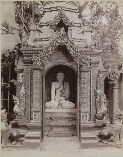 Idol of Buddha in a niche at the Shwedagon pagoda, Yangon, Myanmar