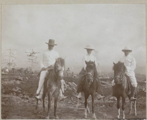 Two Western men and a woman on horseback, Dutch East Indies