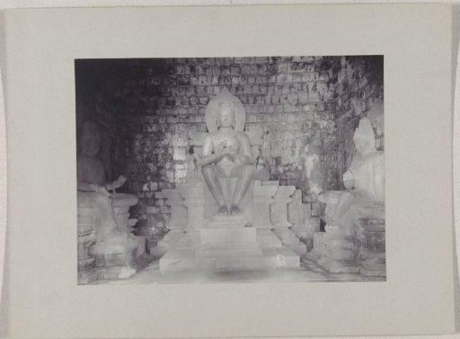 Images of Buddha and two royal sons in the Mendoet Temple south of Magelang, Dutch East Indies