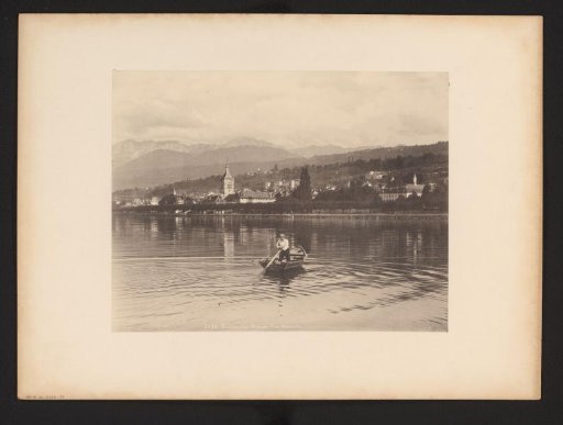 View of Évian-les-Bains with a man in a rowing boat