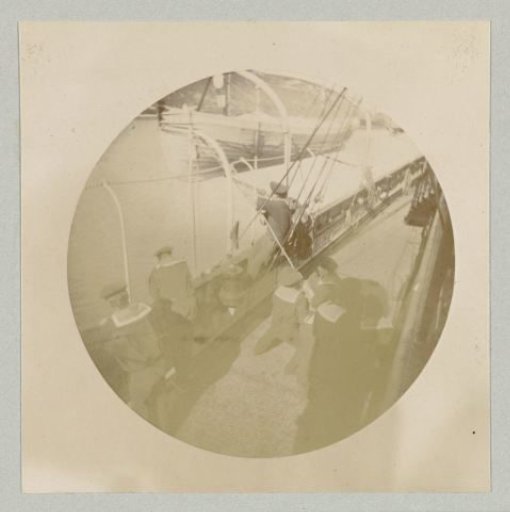 Sailors standing at the railing of a ship