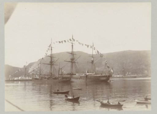 Rowboats sailing to and from the ships of Emperor Wilhelm II, located in a bay