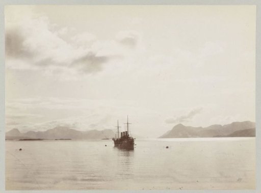 Ship in a bay in Norway with several rowboats nearby