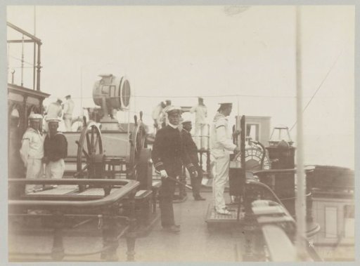Captain and sailors on the upper deck of a ship