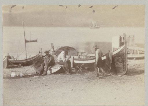 Fishermen hauling their boats ashore