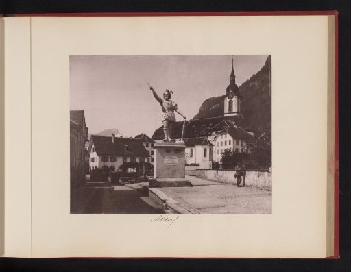 View of a square in Altdorf with a church and a statue of William Tell