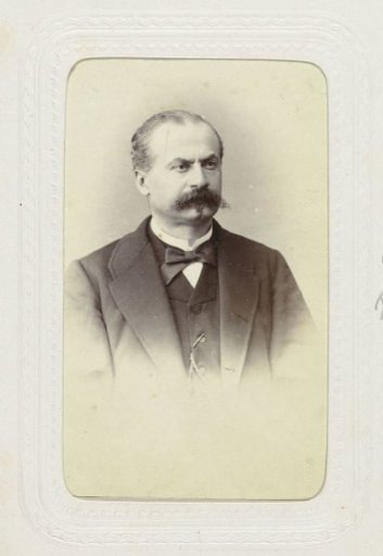 Studio portrait of a man with a mustache in a suit