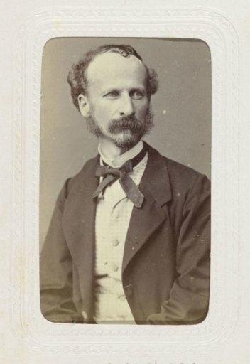 Studio portrait of a man with a mustache and sideburns