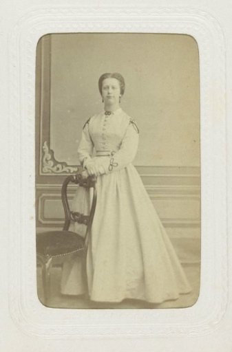 Studio portrait of a woman in a high-closed white dress