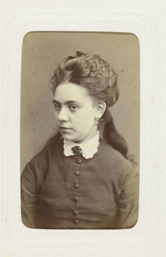 Studio portrait of a young woman with long, dark hair