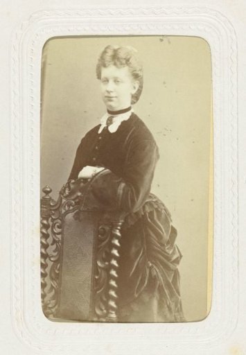 Studio portrait of a blonde woman in a long black dress