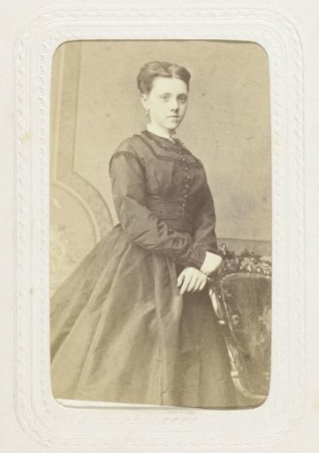 Studio portrait of a young woman in a long black dress