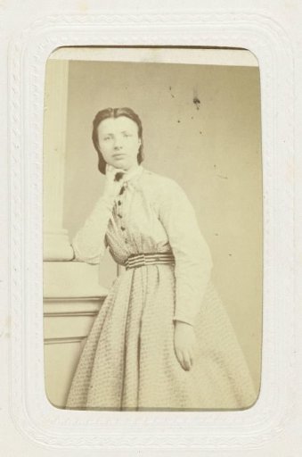 Studio portrait of a young woman in a long black dress