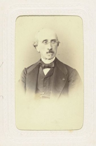 Studio portrait of a bald man with glasses
