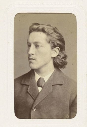 Studio portrait of a young man with half-long hair and a flaxen mustache