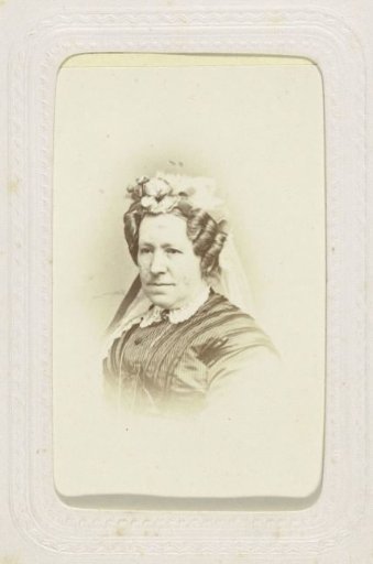 Studio portrait of an older lady with a veil on her head