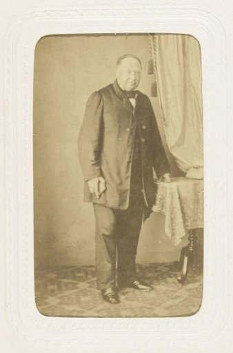 Studio portrait of a man next to a table